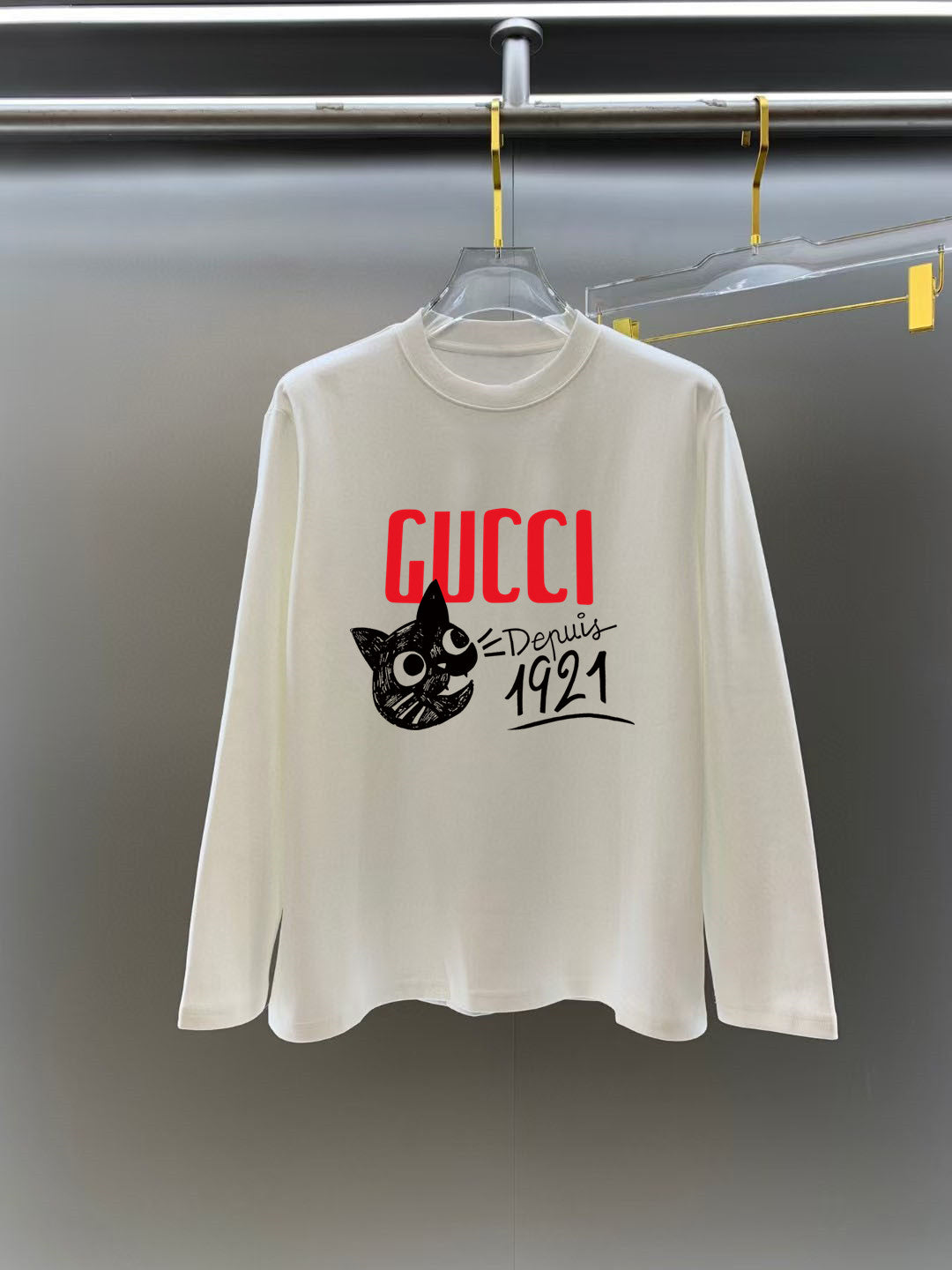 White long-sleeve crewneck T-shirt with red GUCCI logo and black cat graphic