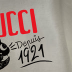 White long-sleeve T-shirt close-up of GUCCI logo and 1921 cat graphic