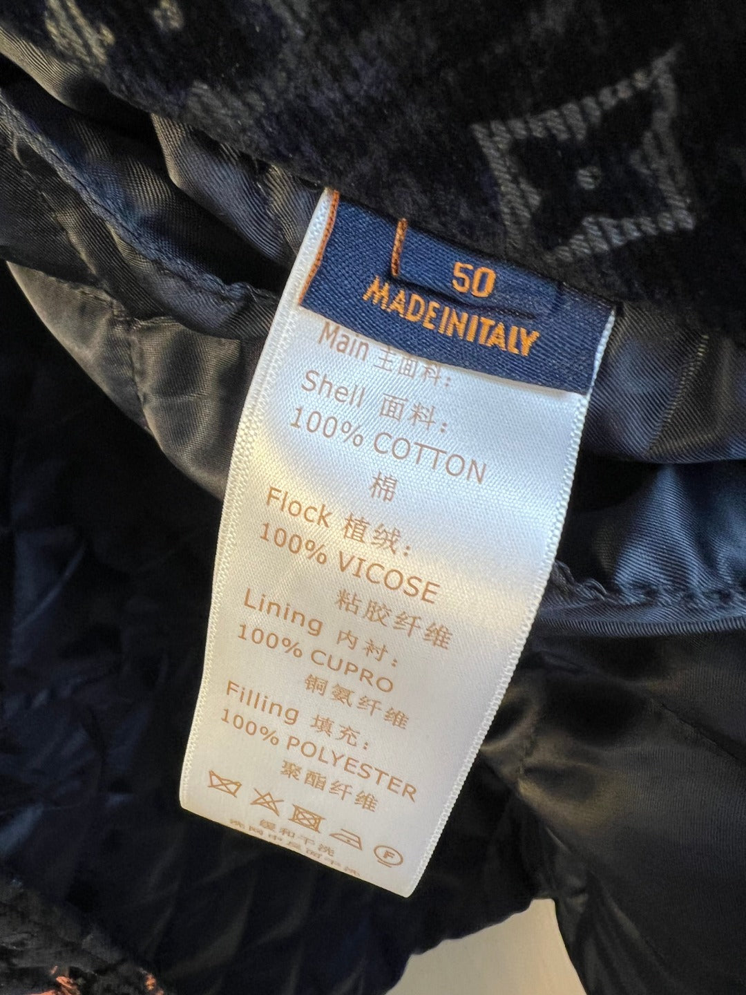 Clothing care label: Made in Italy, 100% cotton shell, viscose lining, polyester fill