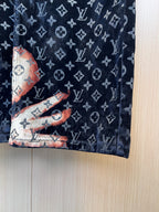 Louis Vuitton monogram pants fabric close-up in dark navy with orange accents