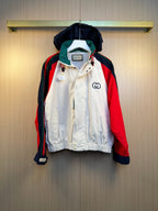 Colorblock hooded jacket with red, navy, green and white panels, front zipper