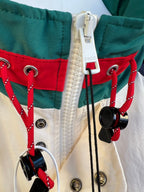Front pocket and drawstring hardware on hooded jacket with red and green panels