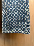 Blue monogram denim pants fabric close-up with repeating pattern
