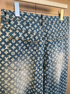 Blue monogram denim pants with front pockets and button closure