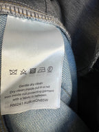 Blue monogram denim pants care label with washing symbols and dry-clean text