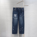 Dark blue denim jeans with Louis Vuitton logo patch and distressed graphic print on leg