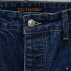 Waistband label of dark blue denim jeans with Louis Vuitton logo and metal button
