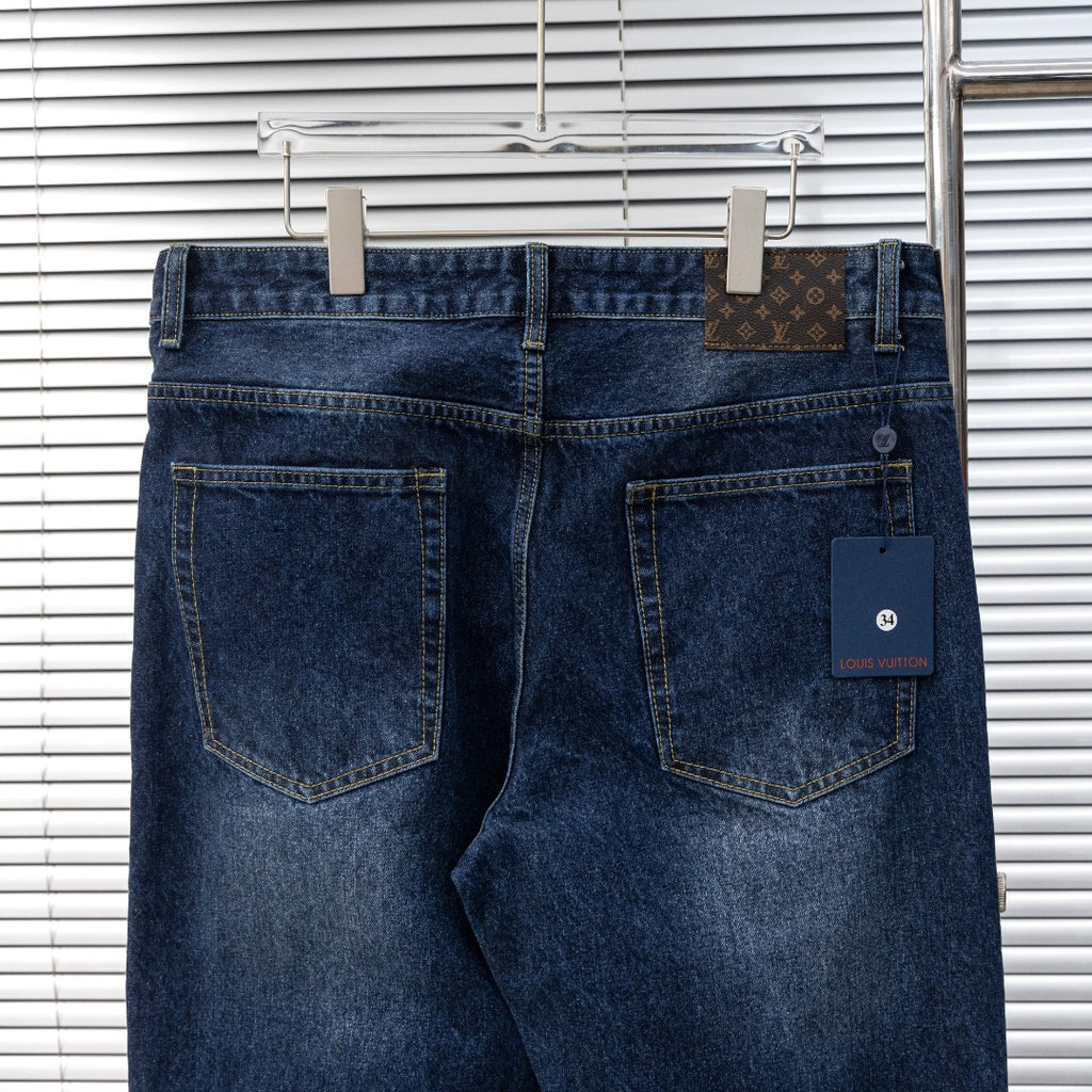 Dark blue denim jeans back view with two patch pockets and Louis Vuitton size tag
