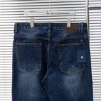 Dark blue denim jeans back view with two patch pockets and Louis Vuitton size tag
