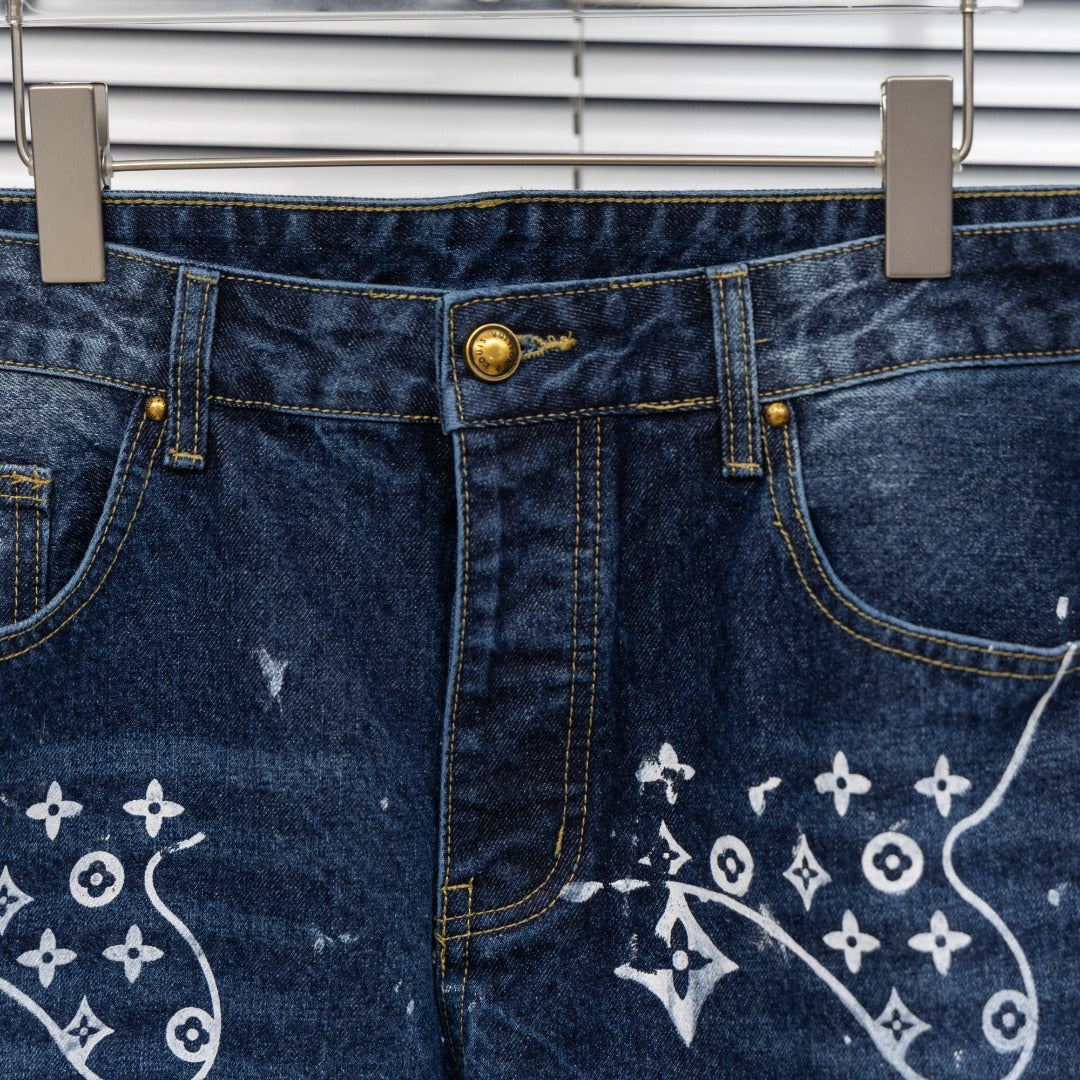Denim pants front detail with gold button closure and white monogram print