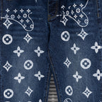 Denim pants close-up of leg print with white monogram motifs and curved lines