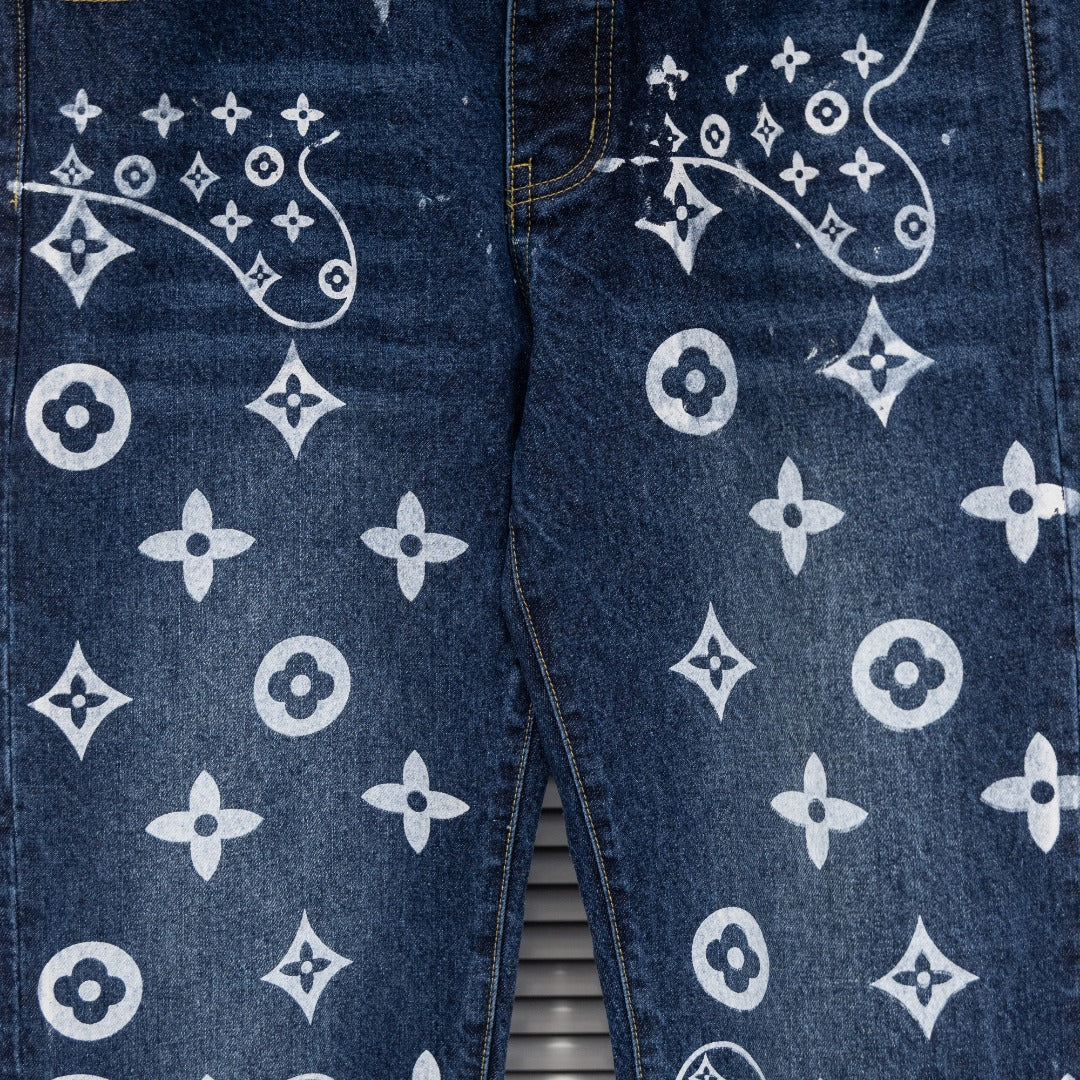 Denim pants close-up of leg print with white monogram motifs and curved lines