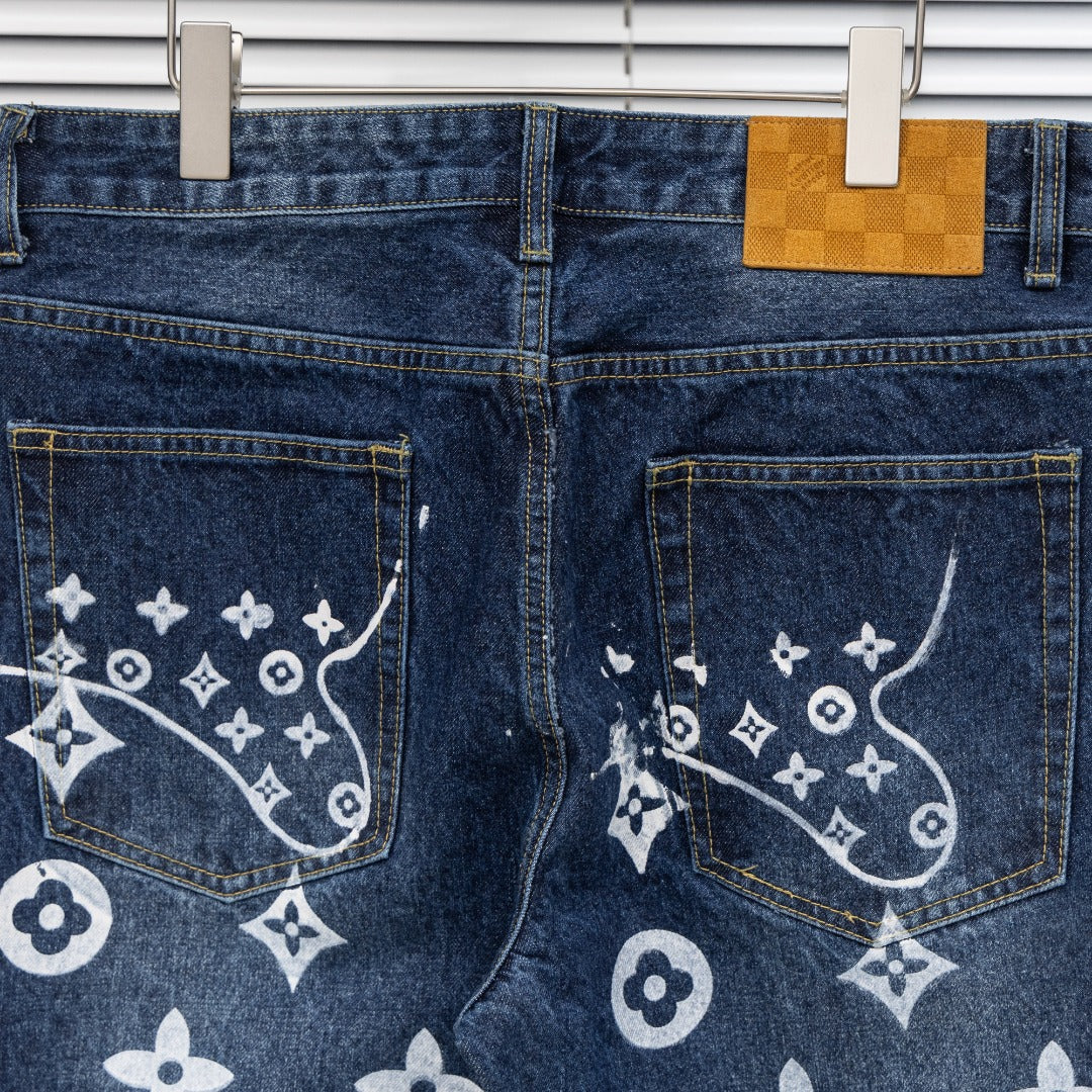 Denim pants back view with two buttoned back pockets and white monogram print