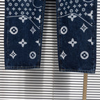 Denim pants hem view with white monogram print on dark blue denim