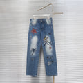 Dior denim pants with colorful star patches and distressed light-wash finish