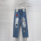 Dior denim pants with colorful star patches and distressed light-wash finish