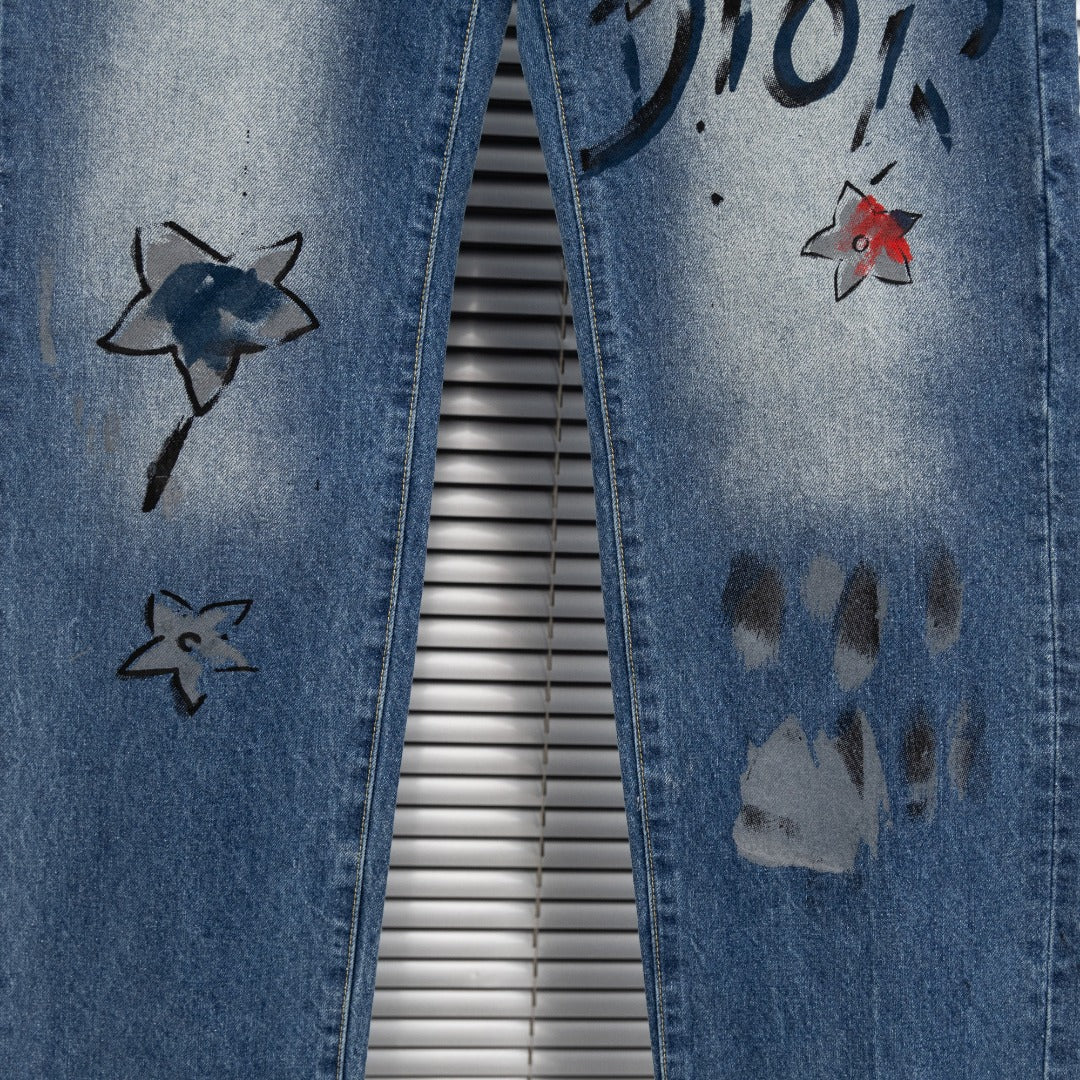 Dior denim pants side with star graphics and dark paint marks on leg