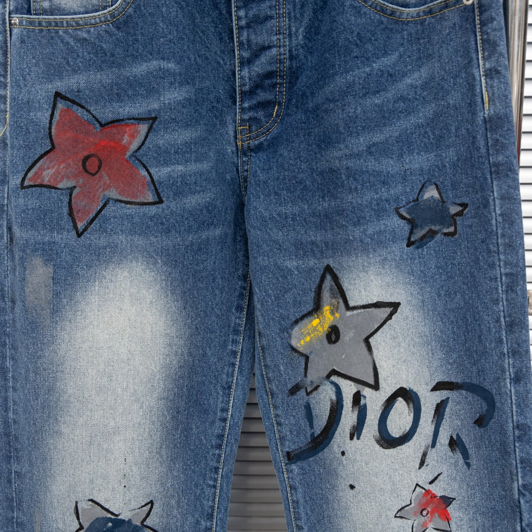 Dior denim pants front with red and black star appliques and DIOR lettering