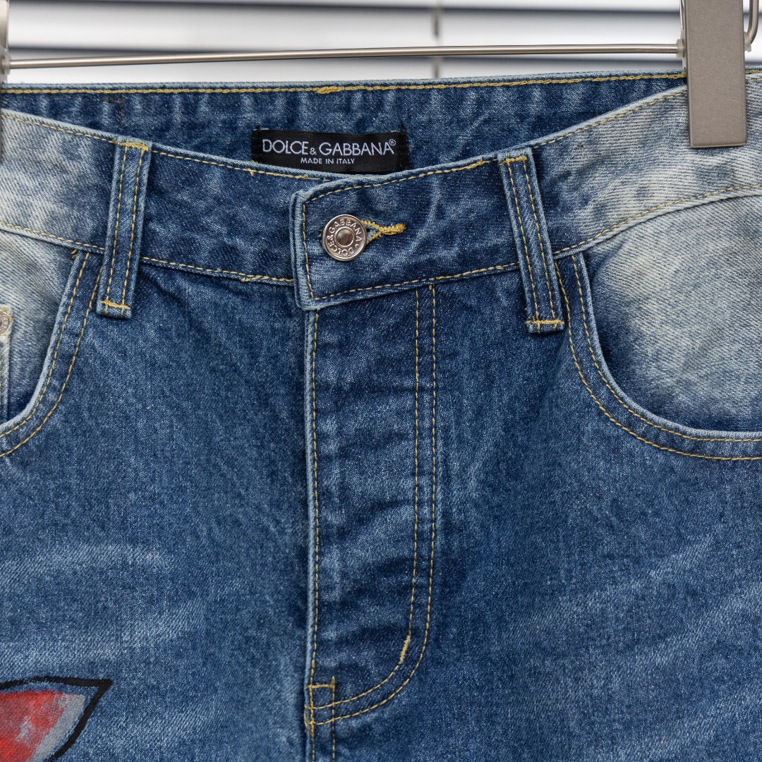 Dior denim pants waistband close-up with Dolce & Gabbana label and button