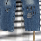 Dior denim pants hem with star graphic and dark paint pawprint motif