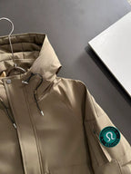 Lightweight hooded jacket in tan, drawstring hood and lululemon logo patch