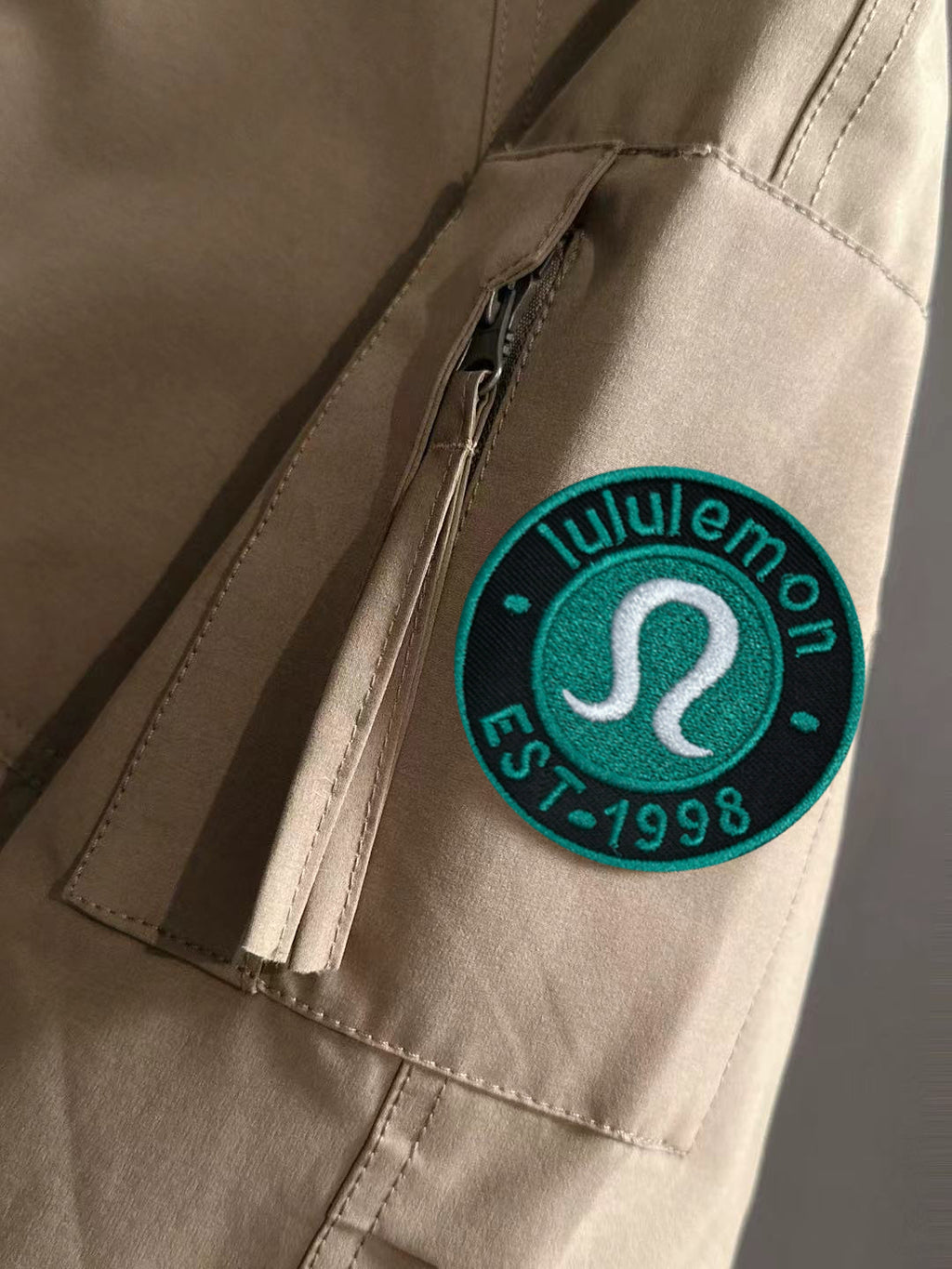 Lightweight jacket sleeve with lululemon logo patch and stitched seams