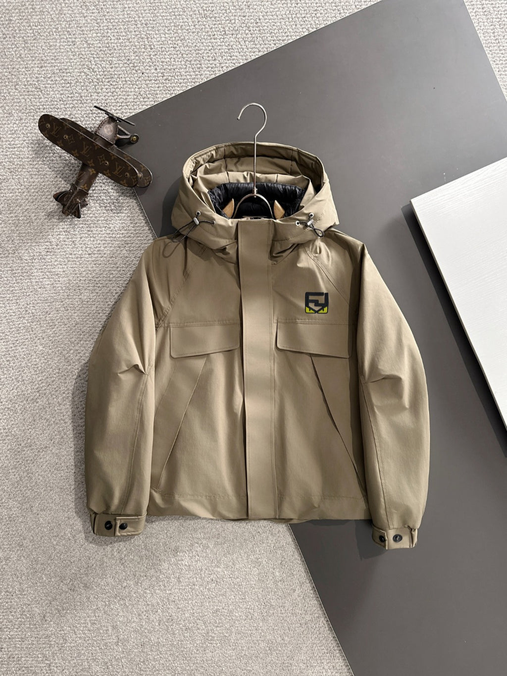 Fendi long parka in light tan with hood, zip front, and snap pockets