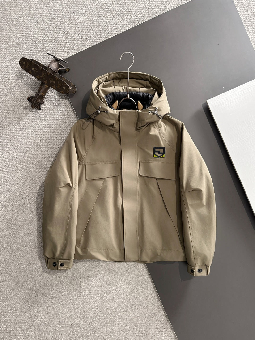 Fendi long parka in light tan with hood, zip front, and snap pockets