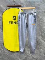 Heather gray Fendi track pants with white drawstring and side stripe, logo on pocket