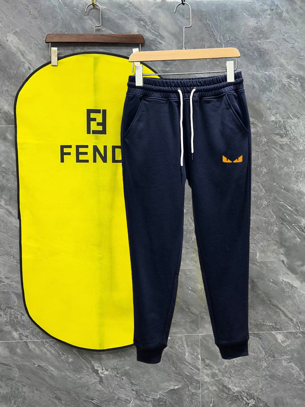 Navy Fendi track pants with white drawstring and side stripe, logo on pocket