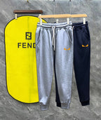 Fendi track pants in heather gray and dark navy with white drawstring and side stripes