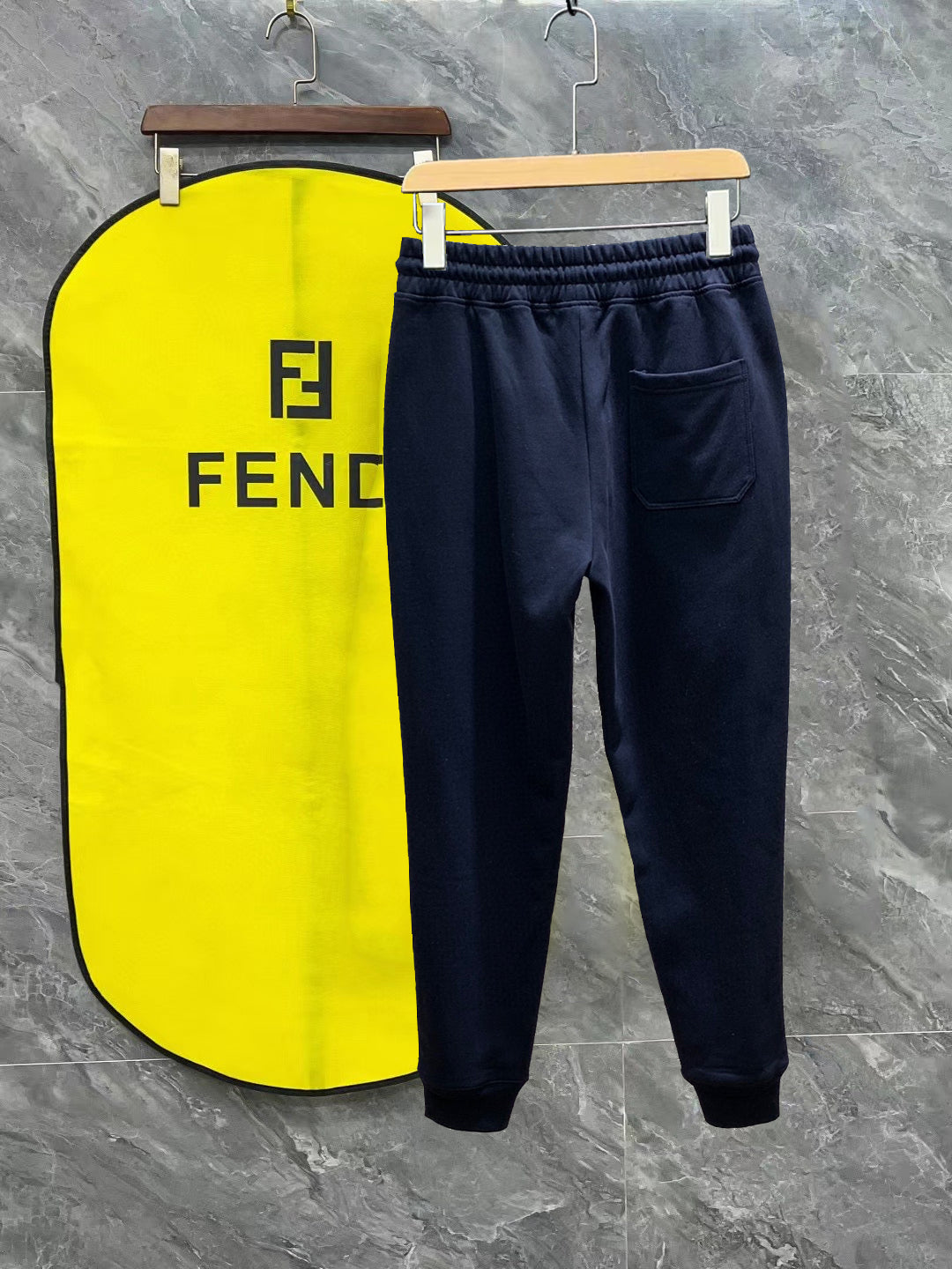 Dark navy Fendi track pants with elastic waistband, drawstring, and side logo patch