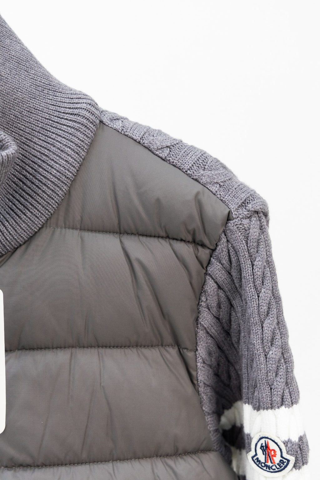 Moncler long puffer jacket side view with quilted gray padded lining