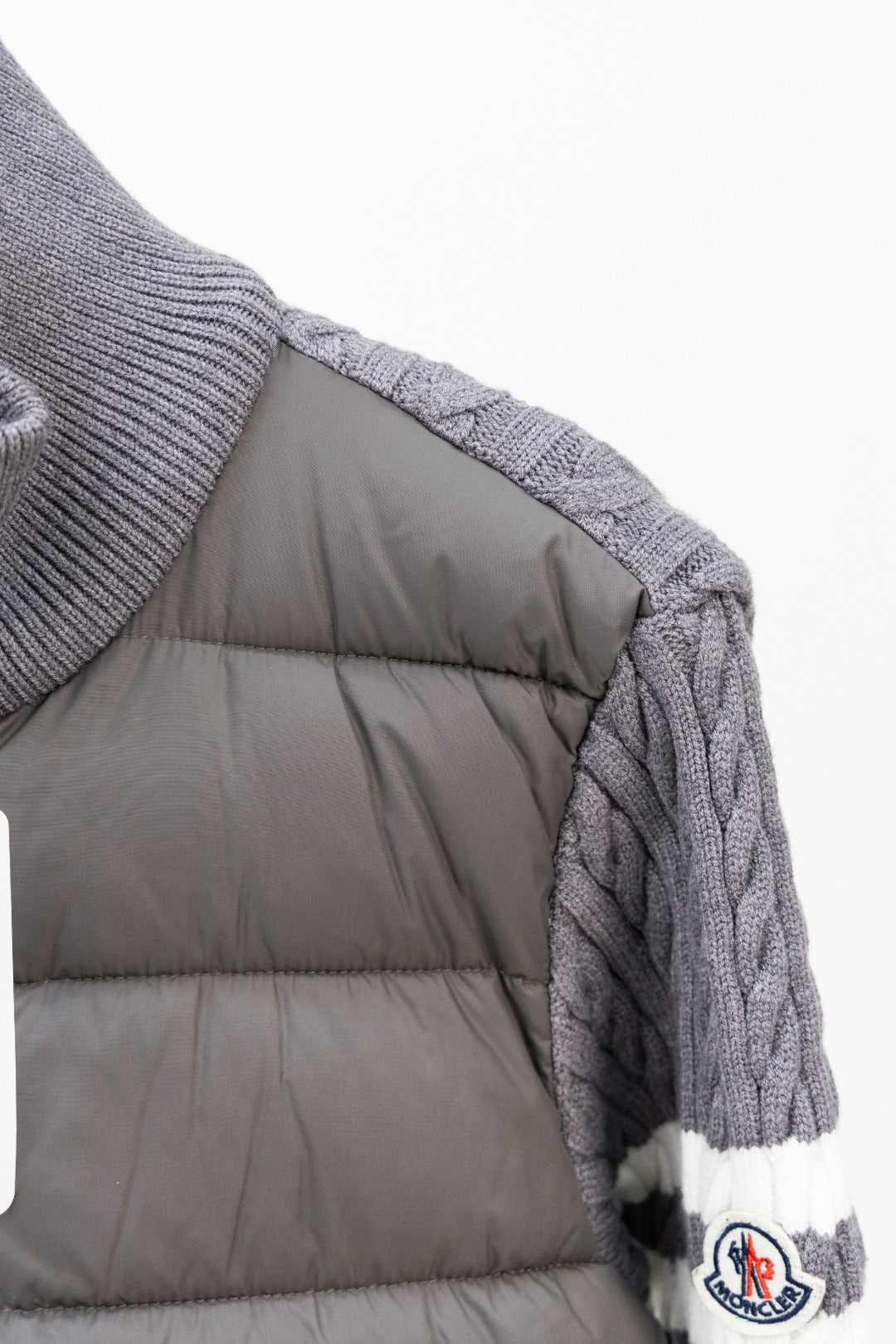 Moncler long puffer jacket side view with quilted gray padded lining