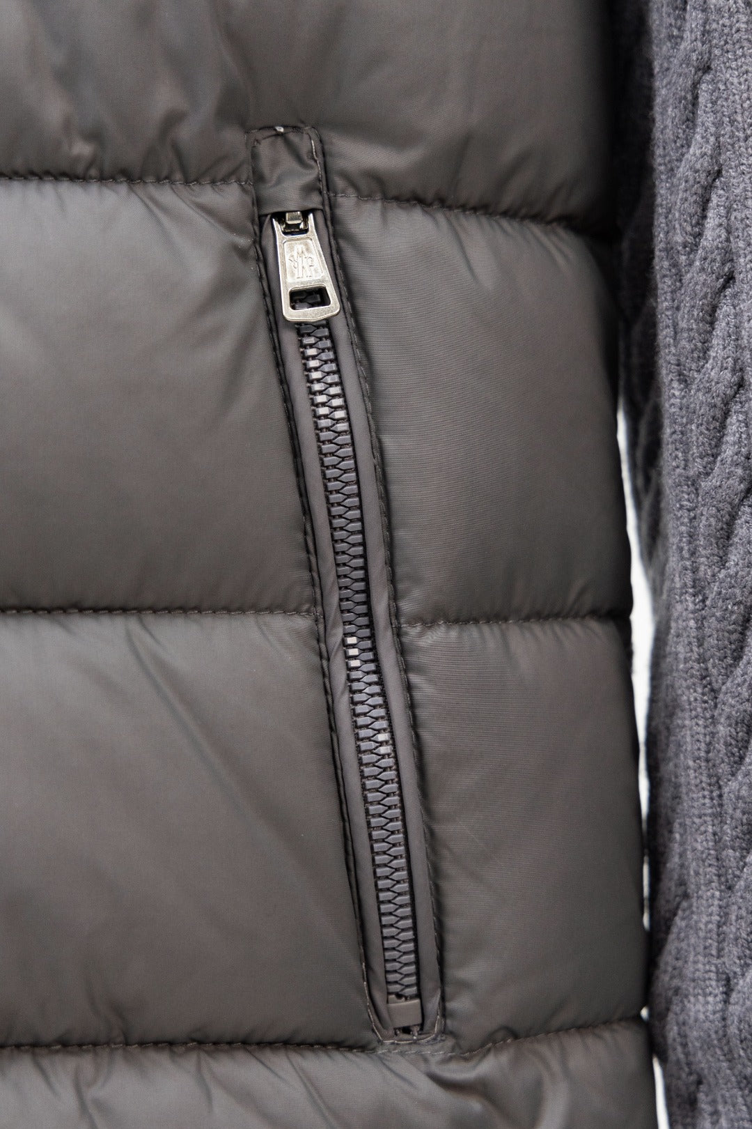 Moncler long puffer jacket front: centered zipper seam on gray quilted fabric