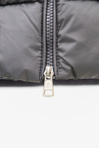 Moncler puffer jacket close-up of dark zipper with metal pull