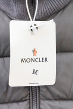 Moncler size tag on gray puffer jacket front zipper