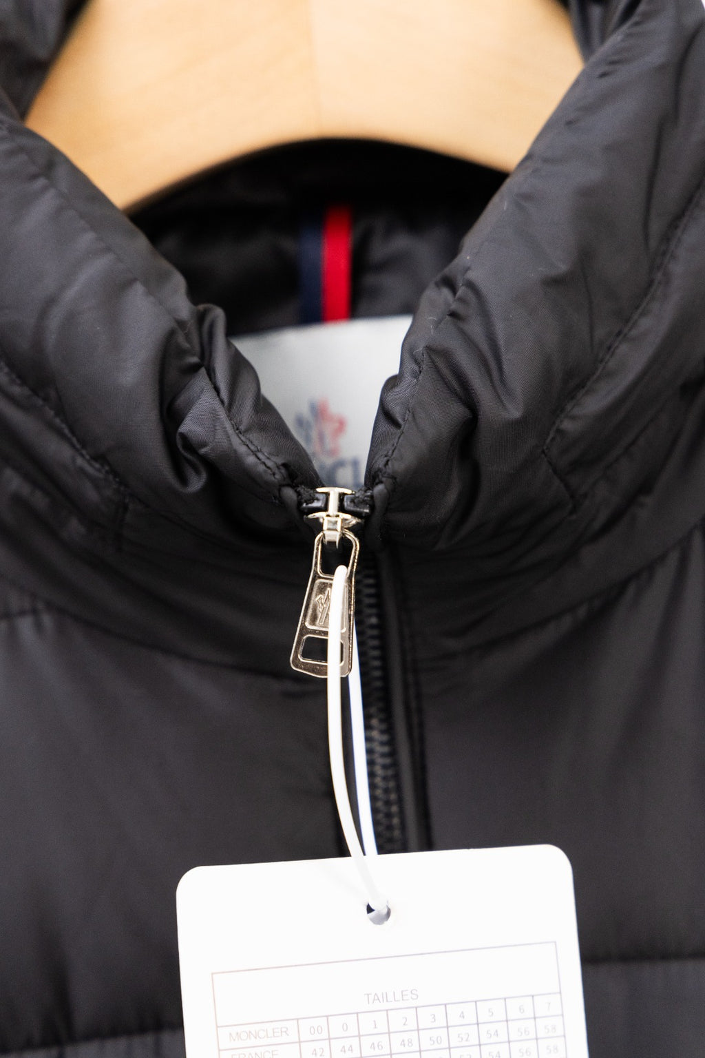 Moncler long black puffer jacket front zip with metal pull and tag