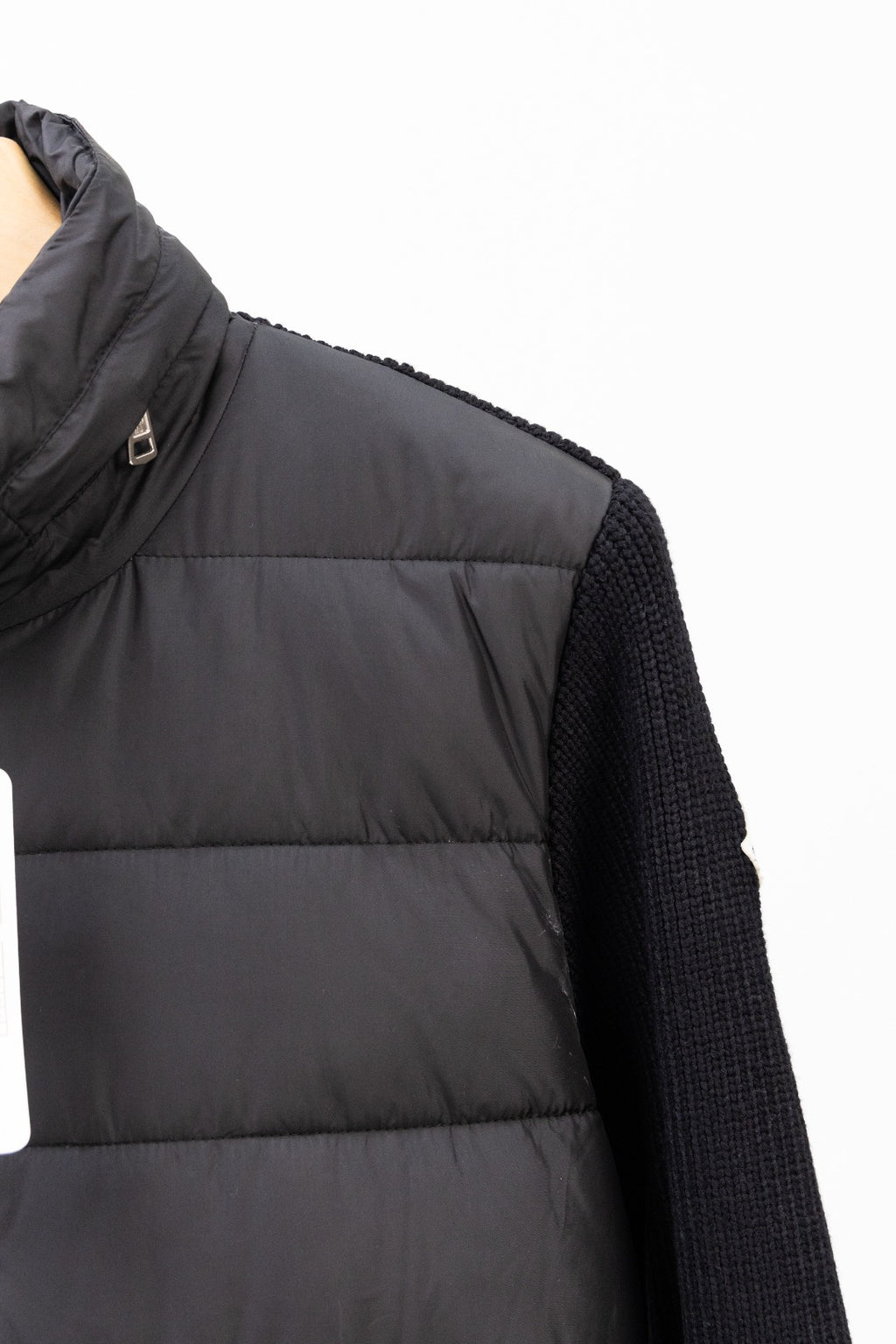 Moncler long black puffer jacket close-up of side seam and knit sleeve