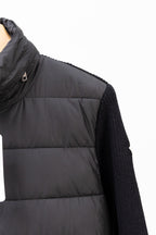 Moncler long black puffer jacket close-up of side seam and knit sleeve