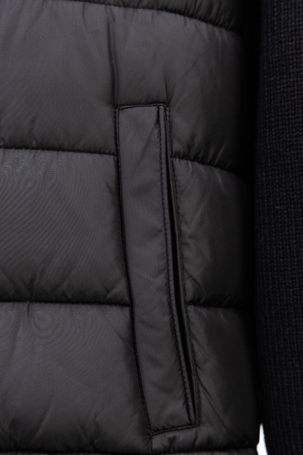 Moncler long black puffer jacket close-up of center zip placket panel