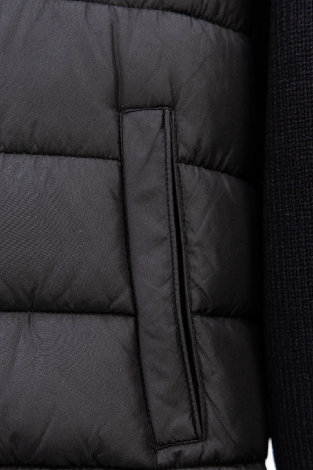 Moncler long black puffer jacket close-up of center zip placket panel