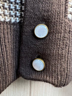Knit cardigan button details with round blue-toned logo buttons