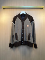 Houndstooth knit cardigan with dark brown ribbed cuffs, hem, and button placket