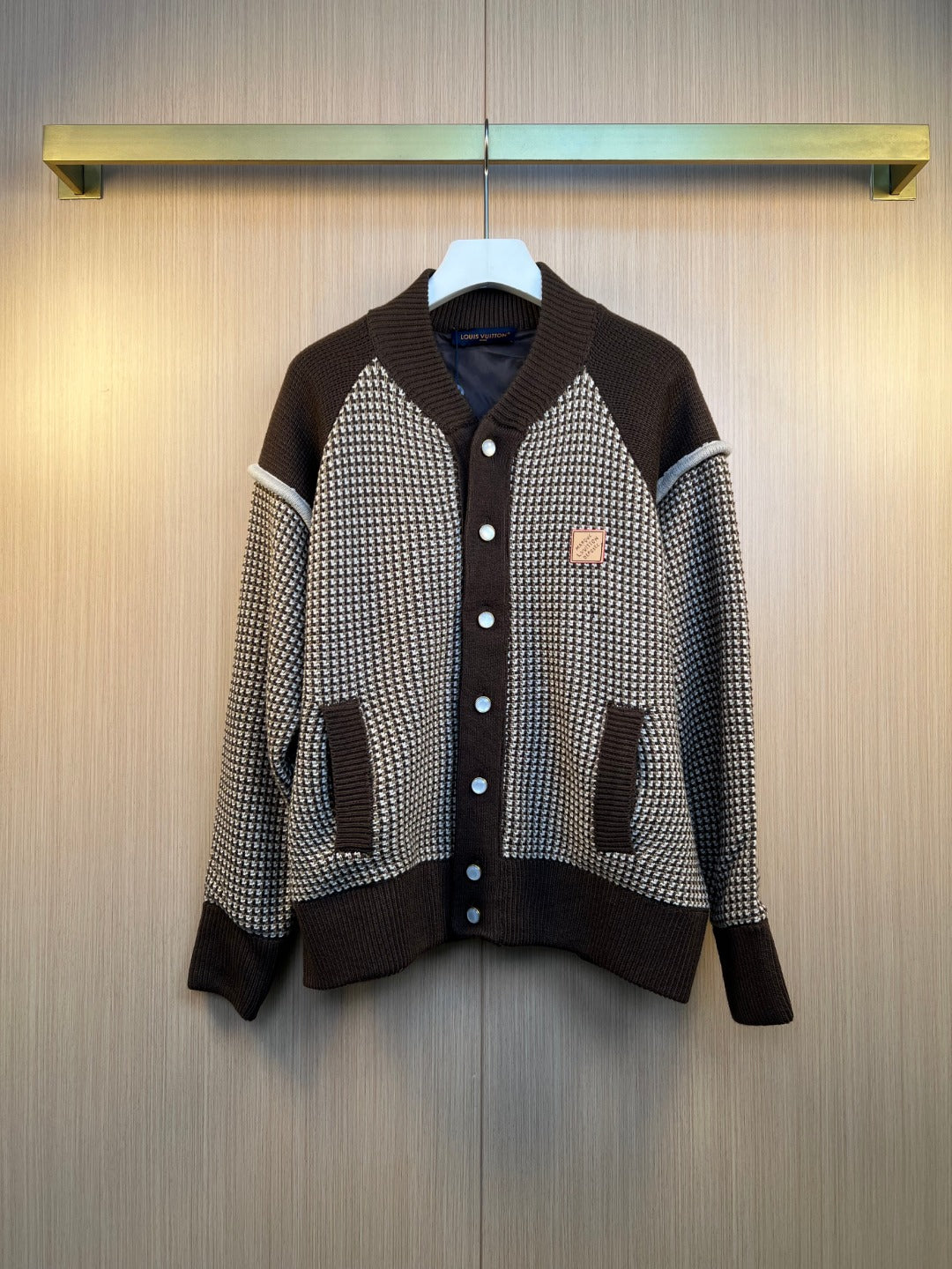 Houndstooth knit cardigan with dark brown ribbed cuffs, hem, and button placket