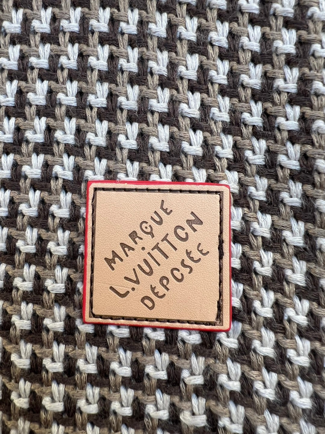 Logo label patch on knit fabric with red border