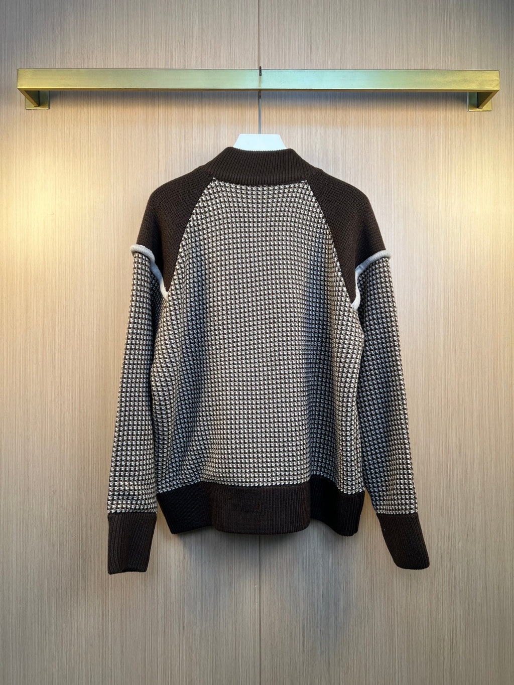 Back view of houndstooth knit cardigan with ribbed dark hem and cuffs