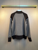 Back view of houndstooth knit cardigan with ribbed dark hem and cuffs