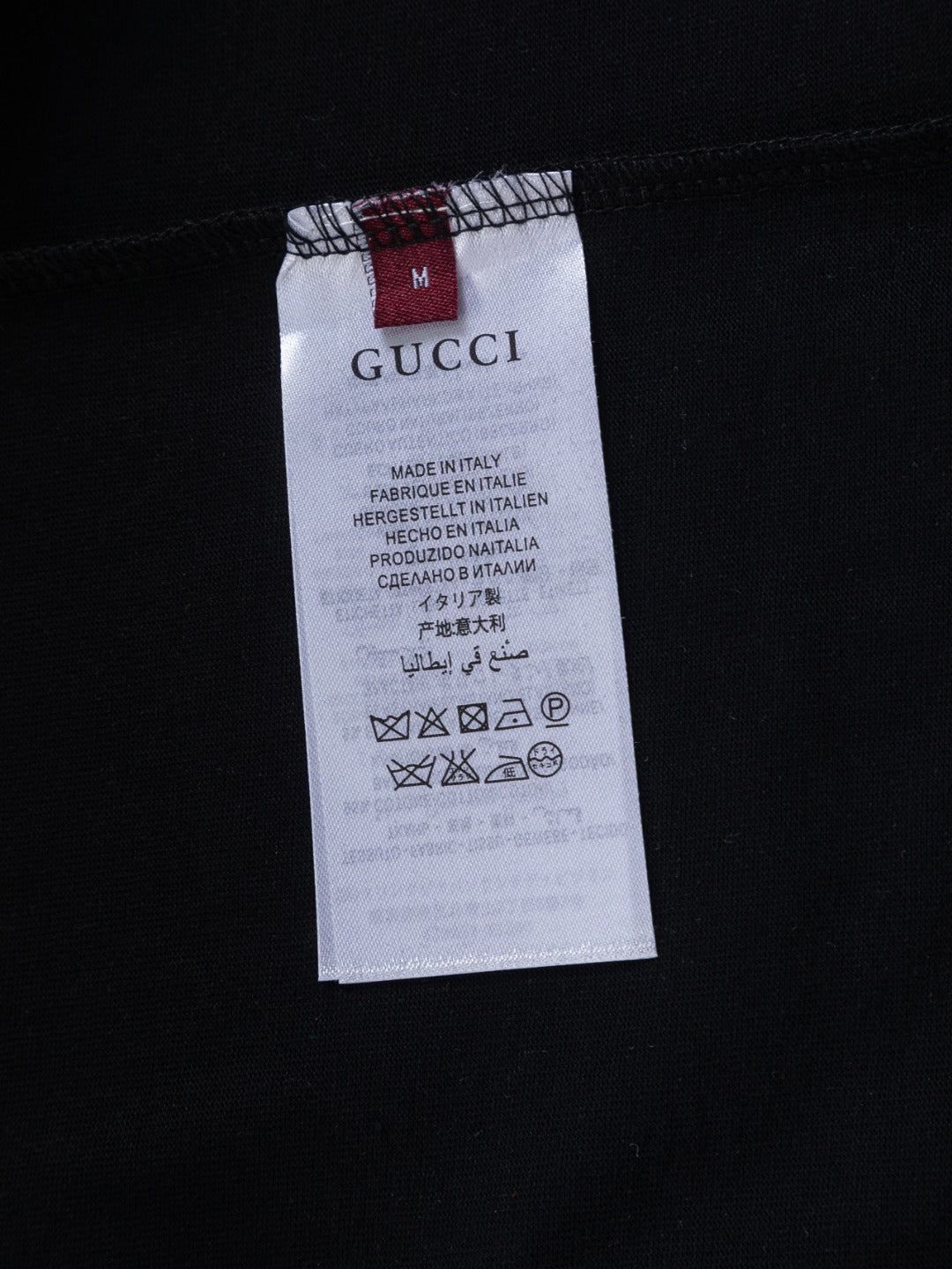 Black Gucci garment with size and care label tag, made in Italy
