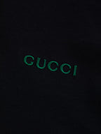 Gucci T-shirt logo on black fabric, green embroidered "GUCCI"